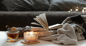 Still life with cup tea books burning candle beautiful candlestick home comfort concept